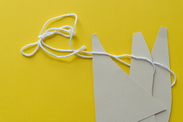 triangular paper shapes with thread on yellow