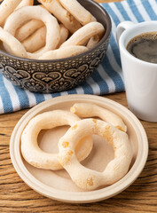 Traditional brazilian polvilho or starch biscuit on a bowl with coffee over wooden table