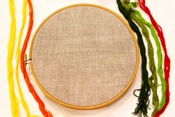 Embroidery hoop with natural linen fabric.