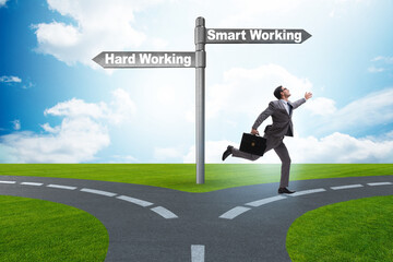 Businessman at the crossroads on working smart or hard