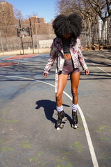 Stylish woman in retro roller skates in park