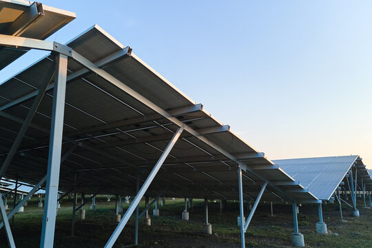 Ground based steel frame of large sustainable electrical power plant with rows of solar photovoltaic panels for producing clean ecological electric energy