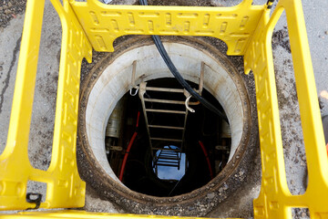 looking down a manhole into the cable vault