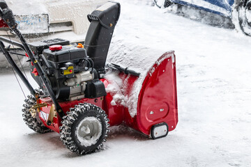 Snow blower in use to clean driveway