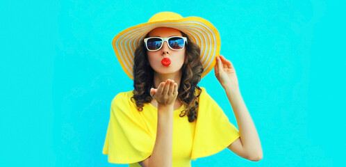 Portrait of beautiful young woman blowing her lips sending sweet air kiss posing wearing yellow...