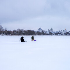 People fishing in frozen river