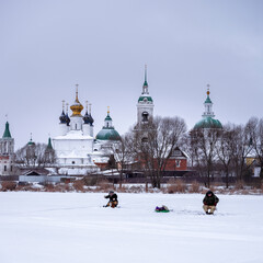 People fishing in frozen river