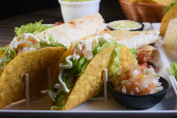 Mexican food, guacamole, nachos, tacos, chili tortillas and quesadillas with salad