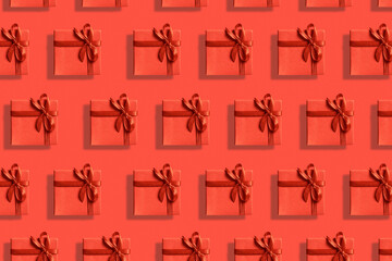 Many bright red gift boxes with ribbon on a red background. Top view