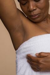 Close-up of woman doing breast cancer self check
