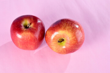 red apple seen from above on pink background