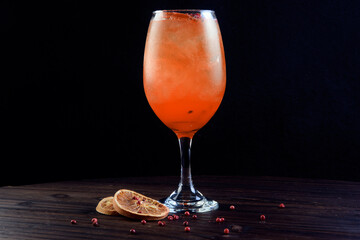 drinks tropical citrus fruits over ice, with sprigs of herbs, grants space for text in blurred background