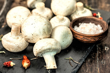 Fresh champignons with spices and herbs. Raw ingredient for cooking vegan food