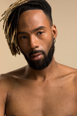 Studio portrait of young man with dreadlocks