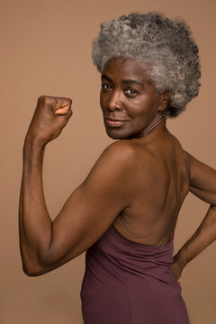 Portrait Of Senior Woman Flexing Muscles