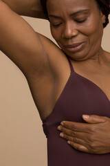 Close-up of woman doing breast cancer self check © Cultura Creative