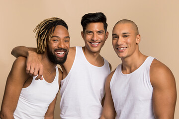 Studio portrait of men in white tank tops