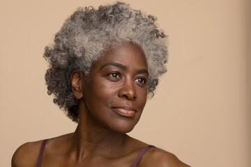 Studio portrait of smiling mature woman