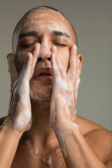 Studio portrait of man washing face