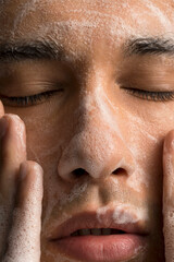 Close-up of man washing face