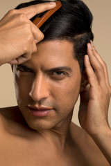 Fototapeta premium Studio portrait of man brushing hair
