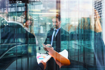 Business people work together in office with stats and reports