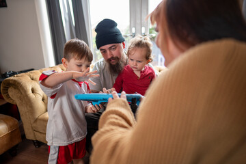 Disabled woman on wheelchair playing with family at home