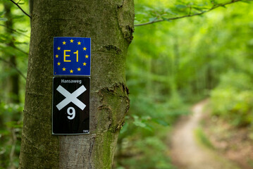 Close-up of the trail marking signs for the “E1 European long distance path” and the “X9...