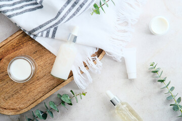 Fototapeta na wymiar Natural organic SPA cosmetic products set with eucalyptus green leaves. Top view herbal skincare beauty products on stone table.