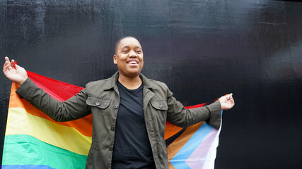 Woman holding pride flag - obrazy, fototapety, plakaty
