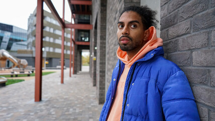 Portrait of young man wearing blue puffer jacket © Cultura Creative