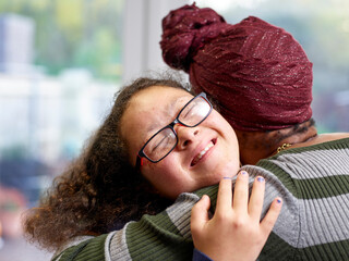 Mother and daughter with Down syndrome hugging