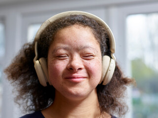 Girl with Down syndrome wearing headphones