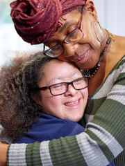 Mother and daughter with Down syndrome hugging - obrazy, fototapety, plakaty