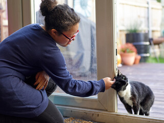 Girl with Down Syndrome stroking cat