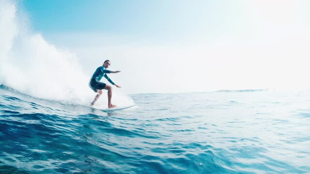 Surfer rides the ocean wave in Maldives