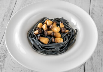 Black pasta with baby mushrooms