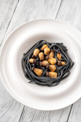 Black pasta with baby mushrooms