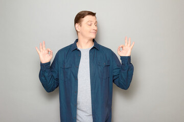 Portrait of happy mature man showing okay gestures and smiling