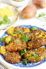 crushed potatoes. smashed potatoes. recipes for Australian cuisine. the potatoes are boiled in a shell, broken and baked in an oven with spices. 