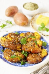 crushed potatoes. smashed potatoes. recipes for Australian cuisine. the potatoes are boiled in a shell, broken and baked in an oven with spices. 