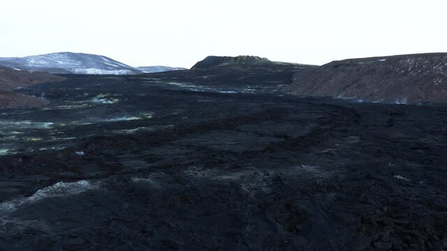 Vast dark black solidified lava field flowing downhill in Iceland, Fagradalsfjall
