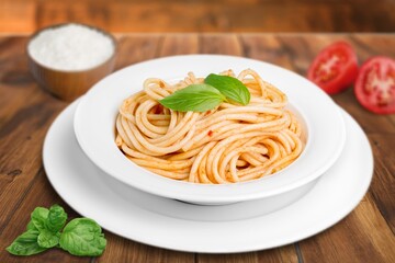 spaghetti pasta with meatballs and sauce, basil, cheese