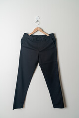 trousers or long pants hanging on wall