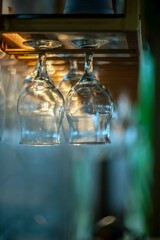 Wine glasses are hanging on Bokeh background.