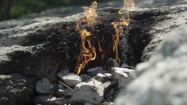 Slowmo close up shot of natural fire in Turkish caves in sunny day. Yanartas