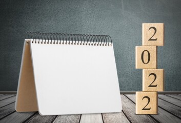 2022 concept with cubes on wooden table background, mockup calendar