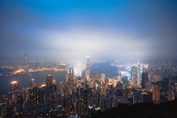 Obraz premium A view of the city at night from the top of the Taiping mountain in Hong Kong.