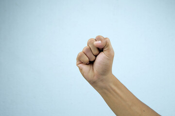 Hand showing strong or independent on gray background