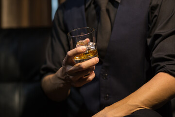 Businessmen in suits drinking whiskey
